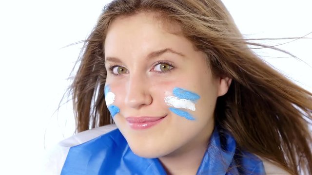 Girl waving Argentinian flag and smiling