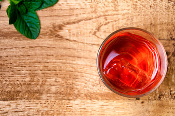 Cold alcohol drink on wooden background