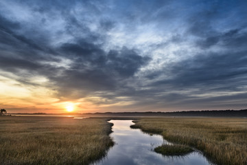 Beautiful Sunrise Along Coastal Inlet with Dramatic Clouds