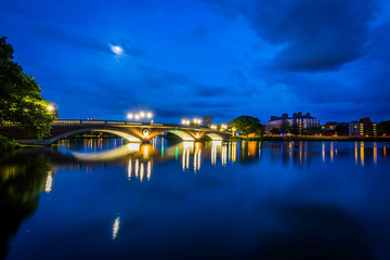 Fototapeta na wymiar The moon over the John W Weeks Bridge and Charles River at night