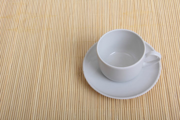 Coffee beans and a white cup on table