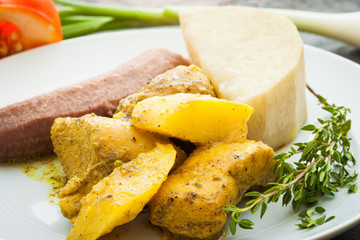 Curried Chicken served with boiled bananas and yams.