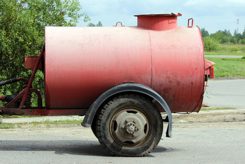 large red watering barrel for  streets hitched to the tractor in the Gatchina Leningrad region