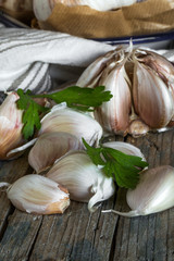 Purple garlics on a napkin on a wooden rustic table