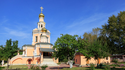 Traditional orthodox temple with gold domes against the blue sky.