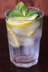 Glass with water and fruits
