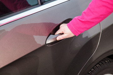 Woman opens car door