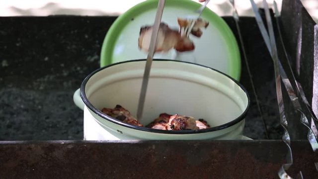 Preparation of roasted meat on the fire outdoors for a picnic and relax.