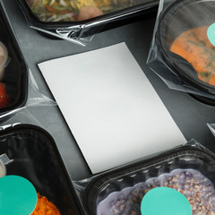 Dietary food in the containers around the white paper
