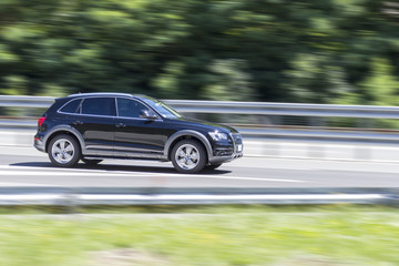 Fototapeta na wymiar car in fast motion with panning effect on highway