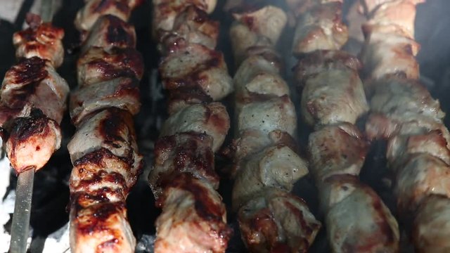 Preparation of roasted meat on the fire outdoors for a picnic and relax.