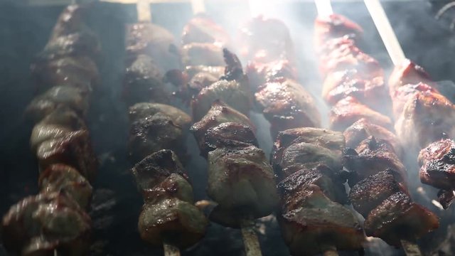 Preparation of roasted meat on the fire outdoors for a picnic and relax.