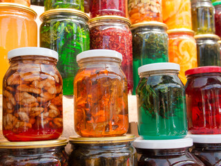Glass jars with sweets stand in a row