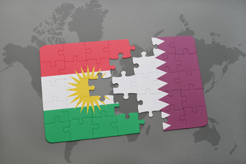 puzzle with the national flag of kurdistan and qatar on a world map background.
