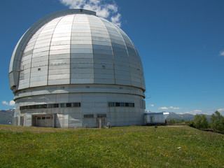 Fototapeta premium Observatory stands on a hill on the sky background