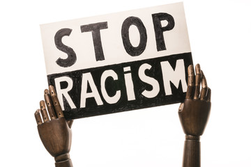 Stop racism: placard brandished by two black hands  On white background.