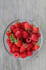 top view of cupping glass filled with raspberries