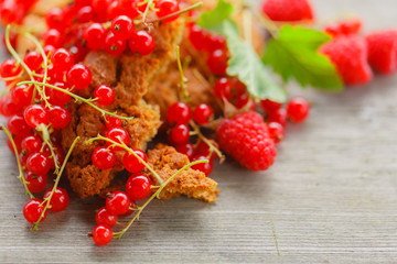 Oat cookiea and Different berries on old wooden table