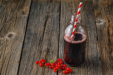 Glass jar of currant mors and fresh red currant © Andrey Cherkasov