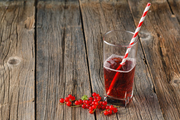 Glass jar of currant mors and fresh red currant © Andrey Cherkasov