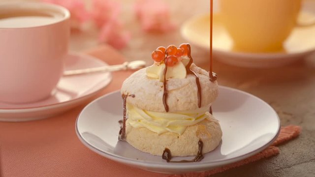 A piece of delicious dessert with pouring chocolate sauce
