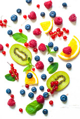 Fresh summer berries and fruits on white