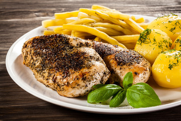 Fried chicken fillets, boiled potatoes and vegetable salad 