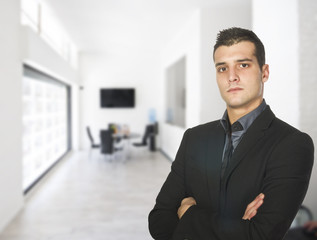 Fototapeta premium Young businessman, smiling to the customers in his office