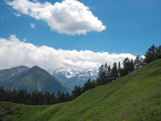 Landscape of mountains with snow on the background of clouds