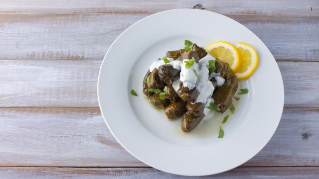 Flat lay of a plate of Yaprak sarma from the Turkish cuisine. Food background and texture. copy space 4K 