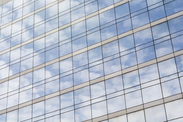 Fototapeta na wymiar Reflection of clouds on a glass facade