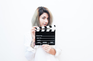 Young blue eyes blonde woman with movie clapper