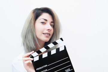 Young blue eyes blonde woman with movie clapper