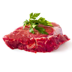Raw beef fillet steak with sprig of parsley on white background, isolated