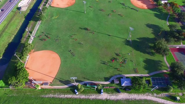 4K AERIAL - Baseball field - with kids playing. 