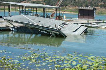 Lake docks broken and collapsing in the water.