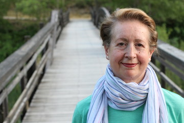 Portrait of a beautiful older woman smiling in the park