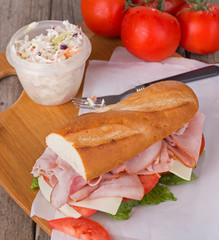 Ham Sub Sandwich With Coleslaw and Vine Tomatoes in Background