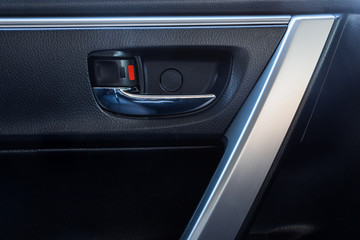 Obraz na płótnie Canvas Door handle inside the modern car is black interior