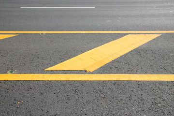 yellow warning sign on asphalt road