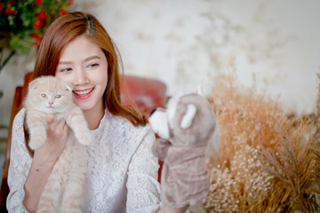 Cute girl and cat Playing with Sock Puppets