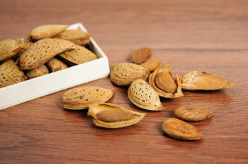 Almonds and almond nuts on a rustic wood background