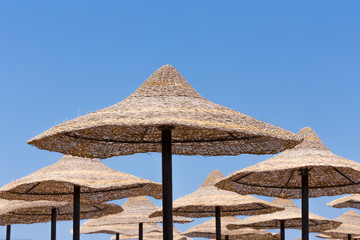 Beach umbrellas and blue sky background