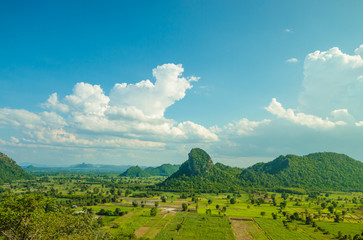 Fototapeta na wymiar rice field and mountain with blue sky in Thailand