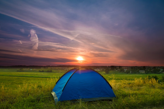 The camping tent stand on the background of picturesque sky. Wide angle