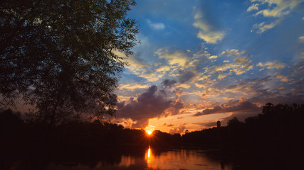 The river on the background of sunset. Wide angle