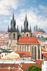 Obraz premium Aerial view of Tyn church in Prague old town and St. Vitus cathedral on background
