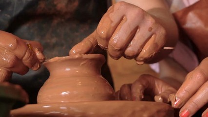 Teacher Helping Student in the Manufacture of Pottery on the Potter's Wheel. Close-Up.