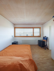 Interior, bedroom with big window. Modern and very straightforward flat. No one is inside. 
