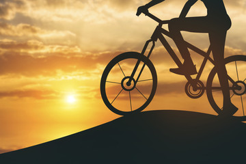 silhouette of Biker girl at the sunset on the mountain.Vintage C